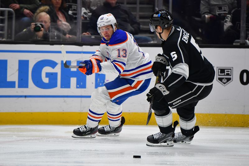 Dec 30, 2023; Los Angeles, California, USA; Edmonton Oilers center Mattias Janmark (13) moves the puck against Los Angeles Kings defenseman Andreas Englund (5) during the third period at Crypto.com Arena. Mandatory Credit: Gary A. Vasquez-USA TODAY Sports