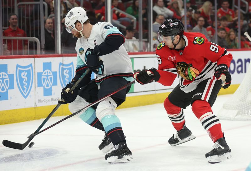 Mar 18, 2025; Chicago, Illinois, USA; Seattle Kraken defenseman Adam Larsson (6) and Chicago Blackhawks right wing Ilya Mikheyev (95) battle for control of the puck during the third period at United Center. Mandatory Credit: Talia Sprague-Imagn Images