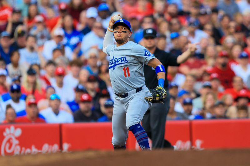 May 24, 2024; Cincinnati, Ohio, USA; Los Angeles Dodgers third baseman Miguel Rojas (11) throws to first to get Cincinnati Reds third baseman Santiago Espinal (not pictured) out in the first inning at Great American Ball Park. Mandatory Credit: Katie Stratman-USA TODAY Sports