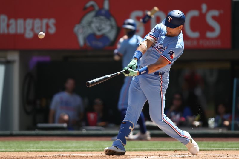 Sep 8, 2024; Arlington, Texas, USA; Texas Rangers first base Nathaniel Lowe (30) hits a two run home run against the Los Angeles Angels in the first inning at Globe Life Field. Mandatory Credit: Tim Heitman-Imagn Images