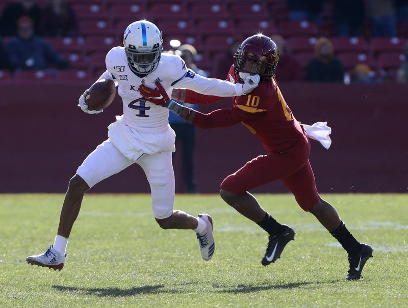 Nov 23, 2019; Ames, IA, USA; Kansas Jayhawks wide receiver Andrew Parchment (4) runs away from Iowa State Cyclones defensive back Tayvonn Kyle (10) at Jack Trice Stadium. Mandatory Credit: Reese Strickland-USA TODAY Sports