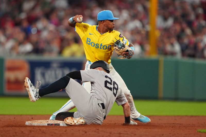 Jul 27, 2024; Boston, Massachusetts, USA; Boston Red Sox shortstop Ceddanne Rafaela (43) throws to first base attempting to complete a double play with New York Yankees catcher Austin Wells (28) sliding into second base during the seventh inning at Fenway Park. Mandatory Credit: Gregory Fisher-USA TODAY Sports