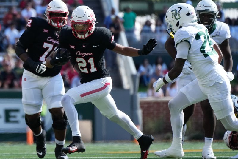 Nov 4, 2023; Waco, Texas, USA;  Houston Cougars running back Stacy Sneed (21) runs the ball against Baylor Bears safety Devyn Bobby (28) during the first half at McLane Stadium. Mandatory Credit: Chris Jones-USA TODAY Sports