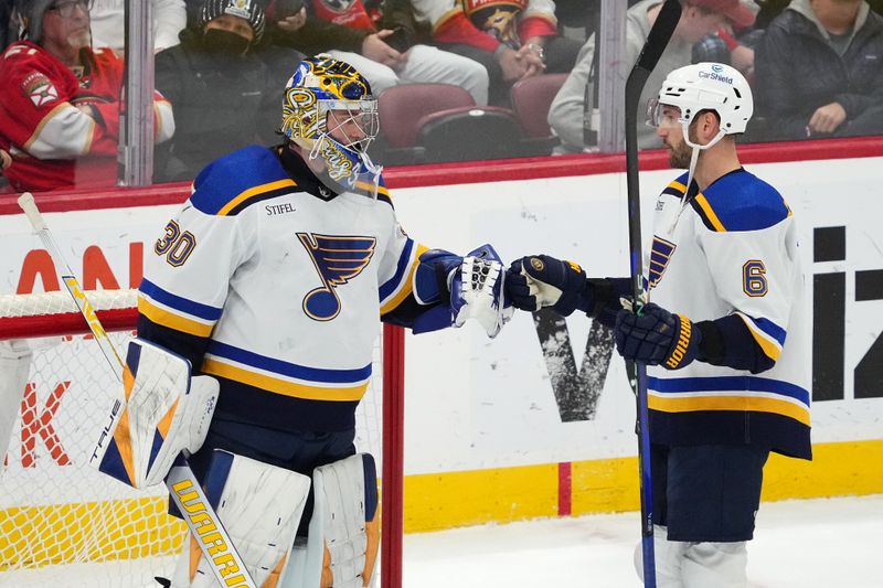 Dec 21, 2023; Sunrise, Florida, USA; St. Louis Blues goaltender Joel Hofer (30) and defenseman Marco Scandella (6) celebrate after defeating the Florida Panthers at Amerant Bank Arena. Mandatory Credit: Jasen Vinlove-USA TODAY Sports