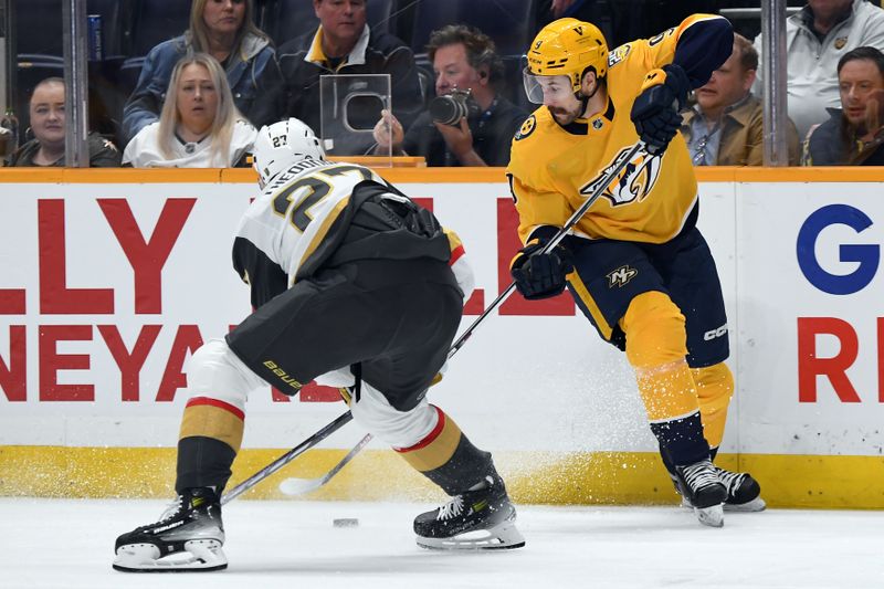 Mar 26, 2024; Nashville, Tennessee, USA; Nashville Predators left wing Filip Forsberg (9) handles the puck along the boards against Vegas Golden Knights defenseman Shea Theodore (27) during the first period at Bridgestone Arena. Mandatory Credit: Christopher Hanewinckel-USA TODAY Sports