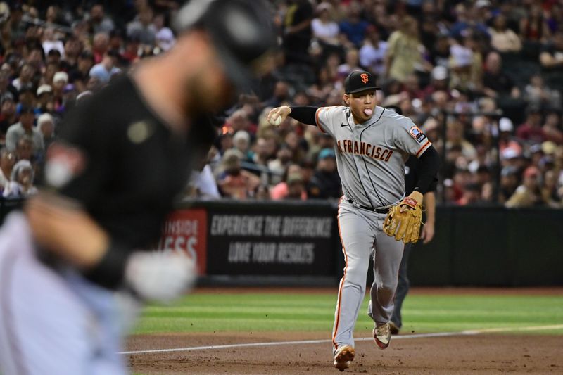 Sep 19, 2023; Phoenix, Arizona, USA; San Francisco Giants first baseman Wilmer Flores (41) throws Arizona Diamondbacks first baseman Christian Walker (53) out at first base in the first inning at Chase Field. Mandatory Credit: Matt Kartozian-USA TODAY Sports