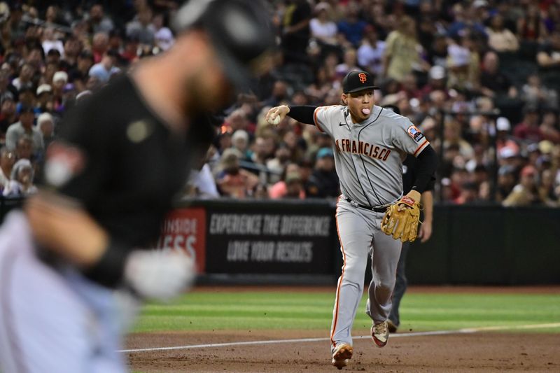 Sep 19, 2023; Phoenix, Arizona, USA; San Francisco Giants first baseman Wilmer Flores (41) throws Arizona Diamondbacks first baseman Christian Walker (53) out at first base in the first inning at Chase Field. Mandatory Credit: Matt Kartozian-USA TODAY Sports