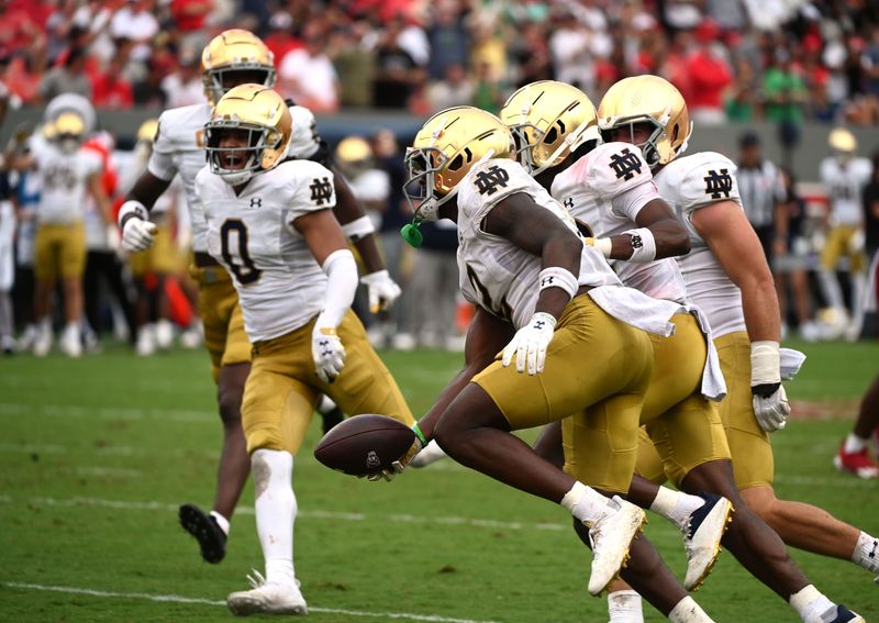 Sep 9, 2023; Raleigh, North Carolina, USA; Notre Dame Fighting Irish safety DJ Brown (2) celebrates an interception with teammates during the second half against the North Carolina State Wolfpack at Carter-Finley Stadium. Mandatory Credit: Rob Kinnan-USA TODAY Sports