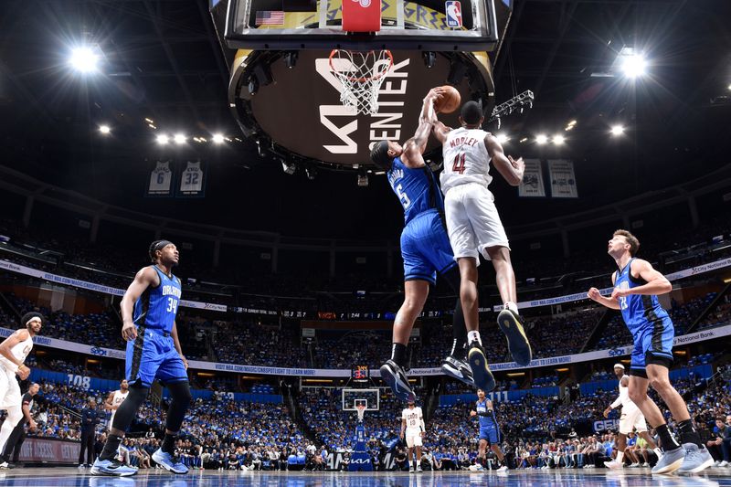 ORLANDO, FL - APRIL 27: Evan Mobley #4 of the Cleveland Cavaliers rebounds the ball during the game against the Orlando Magic during Round 1 Game 4 of the 2024 NBA Playoffs on April 27, 2024 at the Kia Center in Orlando, Florida. NOTE TO USER: User expressly acknowledges and agrees that, by downloading and or using this photograph, User is consenting to the terms and conditions of the Getty Images License Agreement. Mandatory Copyright Notice: Copyright 2024 NBAE (Photo by Fernando Medina/NBAE via Getty Images)