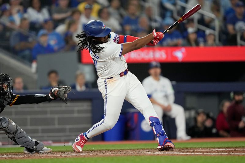 Jun 2, 2024; Toronto, Ontario, CAN; Toronto Blue Jays third baseman Vladimir Guerrero Jr. (27) hits a one run single against the Pittsburgh Pirates during the fifth inning at Rogers Centre. Mandatory Credit: John E. Sokolowski-USA TODAY Sports