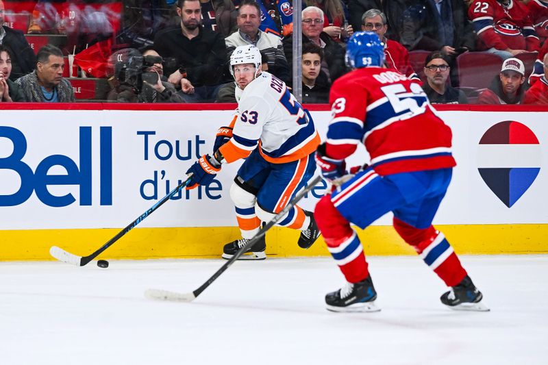Feb 26, 2026; Montreal, Quebec, CAN; New York Islanders center Casey Cizikas (53) controls the puck against Montreal Canadiens defenseman Noah Dobson (53) during the first period at Bell Centre. Mandatory Credit: David Kirouac-Imagn Images