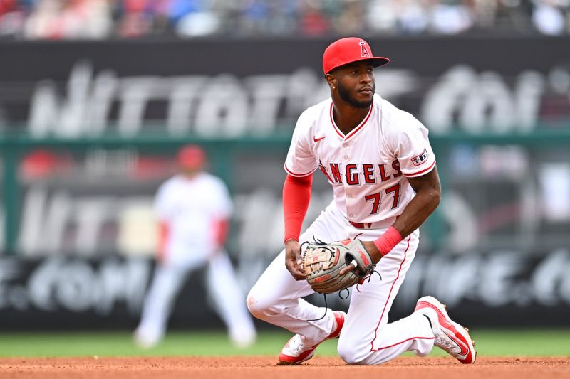 May 4, 2025; Anaheim, California, USA; Los Angeles Angels second baseman Tim Anderson (77) looks to throw the ball against the Detroit Tigers during the fourth inning at Angel Stadium. Mandatory Credit: Jonathan Hui-Imagn Images
