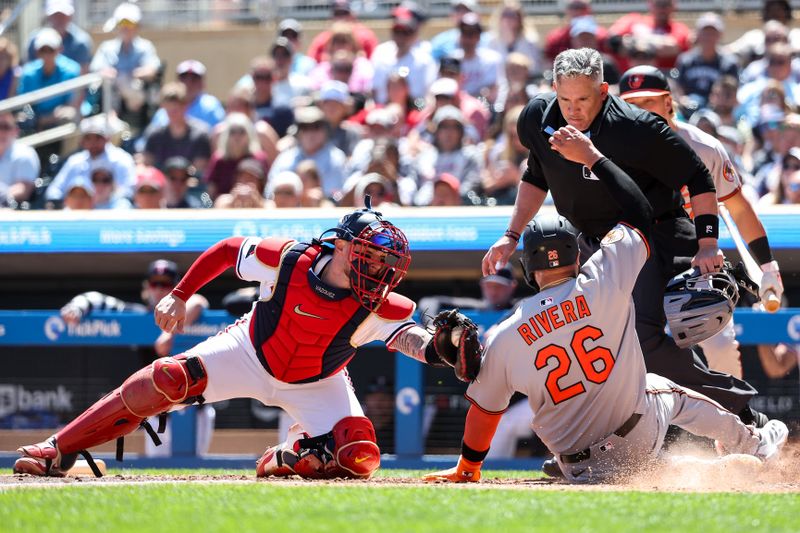 May 8, 2025; Minneapolis, Minnesota, USA; Minnesota Twins catcher Christian Vazquez (8) tags out Baltimore Orioles third baseman Emmanuel Rivera (26) at home plate during the sixth inning at Target Field. Mandatory Credit: Matt Krohn-Imagn Images