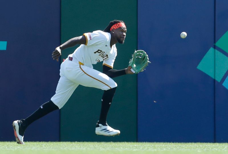 Sep 15, 2024; Pittsburgh, Pennsylvania, USA;  Pittsburgh Pirates center fielder Oneil Cruz (15) makes a catch for an out on a ball hit by Kansas City Royals first baseman Yuli Gurriel (not pictured) during the second inning at PNC Park. Mandatory Credit: Charles LeClaire-Imagn Images