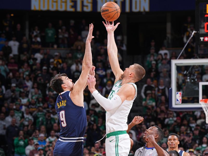 DENVER, CO - JANUARY 7: Dario Saric #9 of the Denver Nuggets and Kristaps Porzingis #8 of the Boston Celtics go up for the opening tip off  on January 7, 2025 at Ball Arena in Denver, Colorado. NOTE TO USER: User expressly acknowledges and agrees that, by downloading and/or using this Photograph, user is consenting to the terms and conditions of the Getty Images License Agreement. Mandatory Copyright Notice: Copyright 2025 NBAE (Photo by Garrett Ellwood/NBAE via Getty Images)