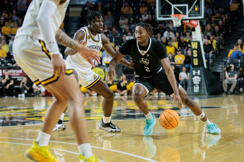 Mar 2, 2024; Wichita, Kansas, USA; Rice Owls guard Mekhi Mason (2) drives to the basket around Wichita State Shockers forward Isaac Abidde (5) during the second halfN at Charles Koch Arena. Mandatory Credit: William Purnell-USA TODAY Sports