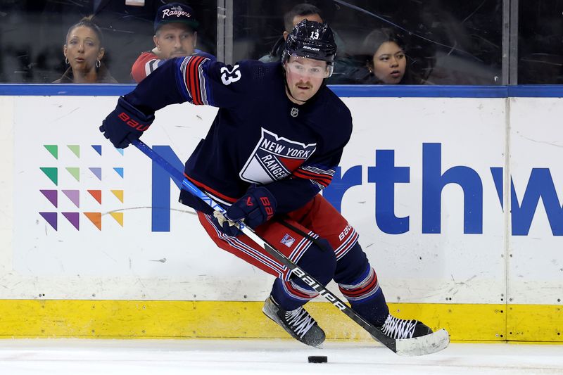 Jan 14, 2024; New York, New York, USA; New York Rangers left wing Alexis Lafreniere (13) skates with the puck against the Washington Capitals during the third period at Madison Square Garden. Mandatory Credit: Brad Penner-USA TODAY Sports