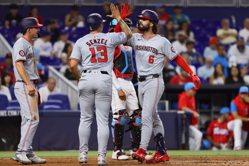 Apr 27, 2024; Miami, Florida, USA; Washington Nationals left fielder Jesse Winker (6) celebrates with designated hitter Nick Senzel (13) after hitting a grand slam against the Miami Marlins during the fifth inning at loanDepot Park. Mandatory Credit: Sam Navarro-USA TODAY Sports