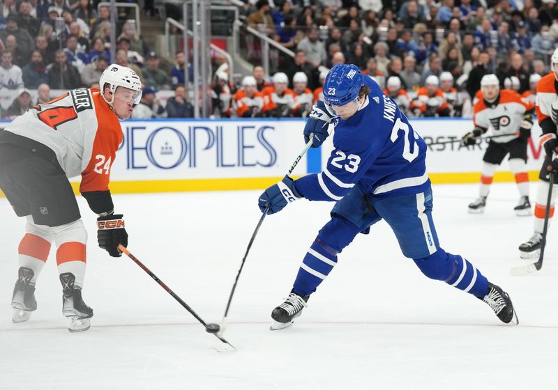 Feb 15, 2024; Toronto, Ontario, CAN; Toronto Maple Leafs left wing Matthew Knies (23) shoots the puck as Philadelphia Flyers defenseman Nick Seeler (24) tries to block during the first period at Scotiabank Arena. Mandatory Credit: Nick Turchiaro-USA TODAY Sports