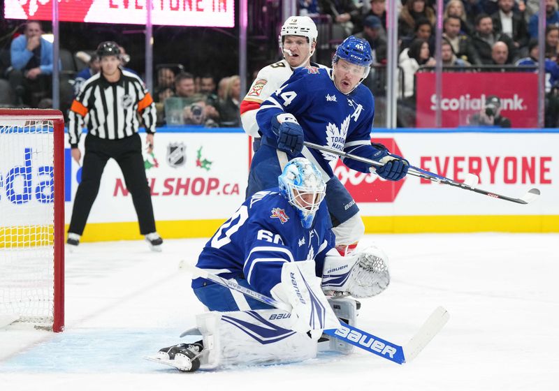 Nov 28, 2023; Toronto, Ontario, CAN; Florida Panthers left wing Matthew Tkachuk (19) battle in front of the net with Toronto Maple Leafs defenseman Morgan Rielly (44) during the second period at Scotiabank Arena. Mandatory Credit: Nick Turchiaro-USA TODAY Sports