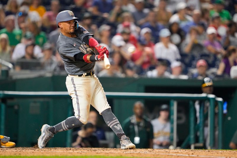 Aug 11, 2023; Washington, District of Columbia, USA; Washington Nationals third baseman Ildemaro Vargas (14) hits a three-run home run against the Oakland Athletics during the seventh inning at Nationals Park. Mandatory Credit: Gregory Fisher-USA TODAY Sports