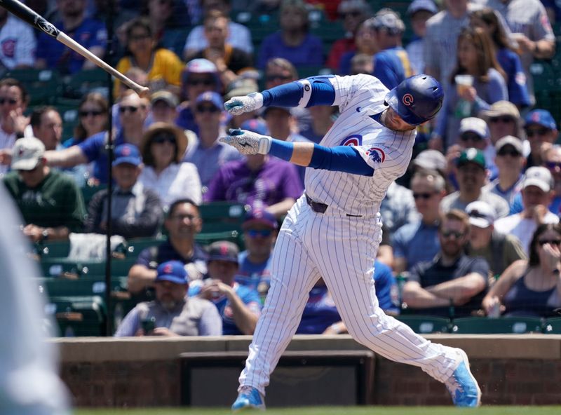 May 17, 2024; Chicago, Illinois, USA; Chicago Cubs outfielder Ian Happ (8) loses his bat after swinging at a pitch against the Pittsburgh Pirates during the first inning at Wrigley Field. Mandatory Credit: David Banks-USA TODAY Sports