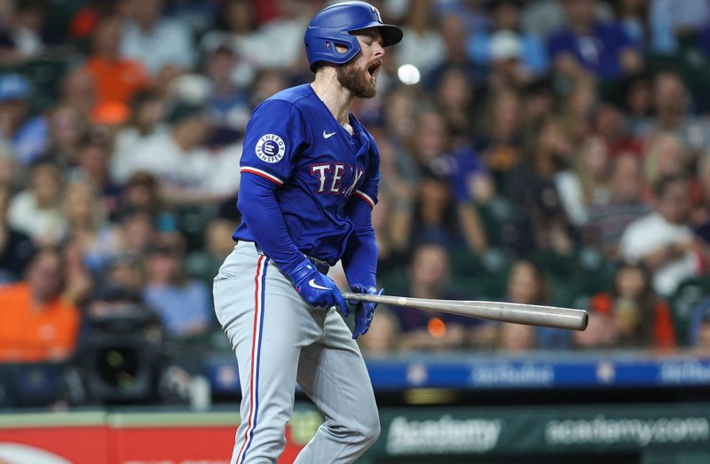 Apr 12, 2024; Houston, Texas, USA; Texas Rangers first baseman Jared Walsh (21) reacts after striking out during the fifth inning against the Houston Astros at Minute Maid Park. Mandatory Credit: Troy Taormina-USA TODAY Sports