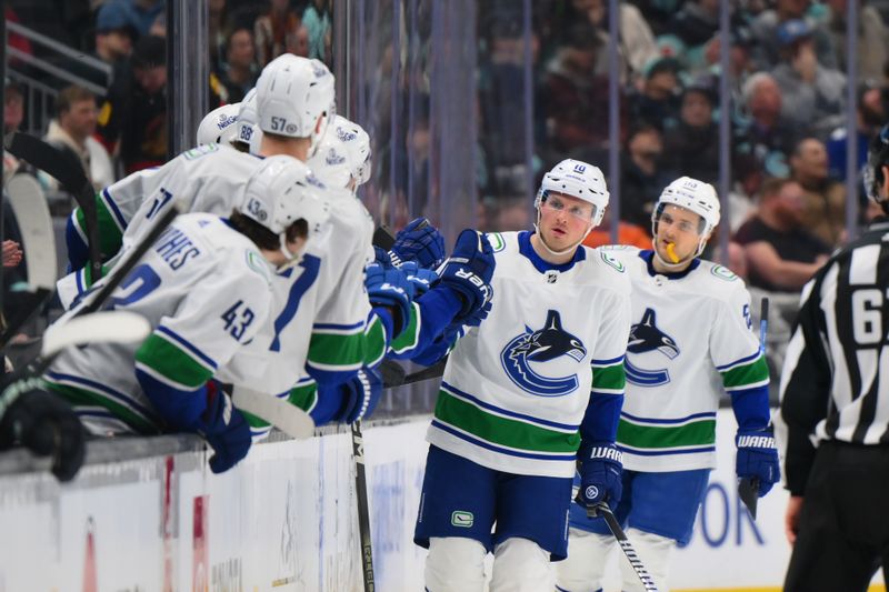 Feb 22, 2024; Seattle, Washington, USA; Vancouver Canucks center Sam Lafferty (18) celebrates with the bench after scoring a goal against the Seattle Kraken during the second period at Climate Pledge Arena. Mandatory Credit: Steven Bisig-USA TODAY Sports