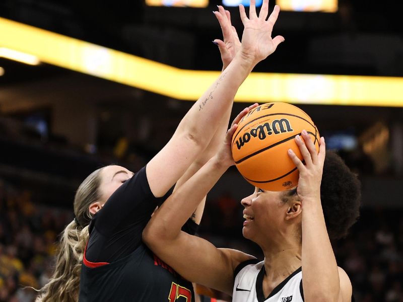 Mar 4, 2023; Minneapolis, MINN, USA; Iowa Hawkeyes forward Hannah Stuelke (45) shoots while Maryland Terrapins guard Faith Masonius (13) defends during the first half at Target Center. Mandatory Credit: Matt Krohn-USA TODAY Sports