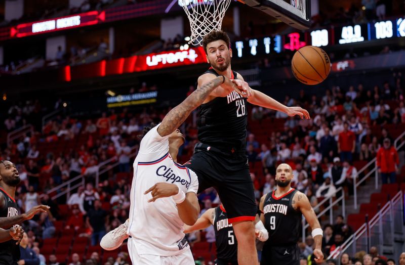 HOUSTON, TEXAS - NOVEMBER 13: Alperen Sengun #28 of the Houston Rockets blocks a shot by Jordan Miller #11 of the Los Angeles Clippers in the fourth quarter at Toyota Center on November 13, 2024 in Houston, Texas.  NOTE TO USER: User expressly acknowledges and agrees that, by downloading and or using this photograph, User is consenting to the terms and conditions of the Getty Images License Agreement.  (Photo by Tim Warner/Getty Images)