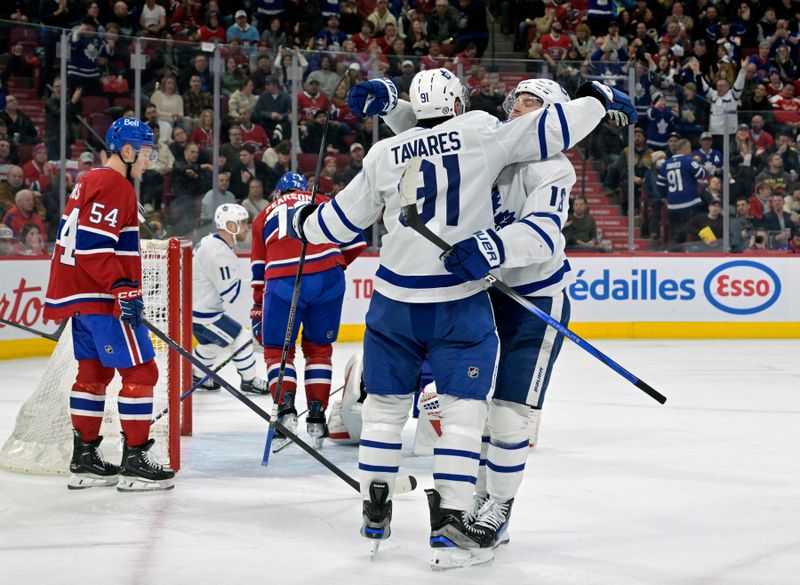 Mar 9, 2024; Montreal, Quebec, CAN; Toronto Maple Leafs forward John Tavares (91) celebrates with teammates after scoring a goal against the Montreal Canadiens during the third period at the Bell Centre. Mandatory Credit: Eric Bolte-USA TODAY Sports