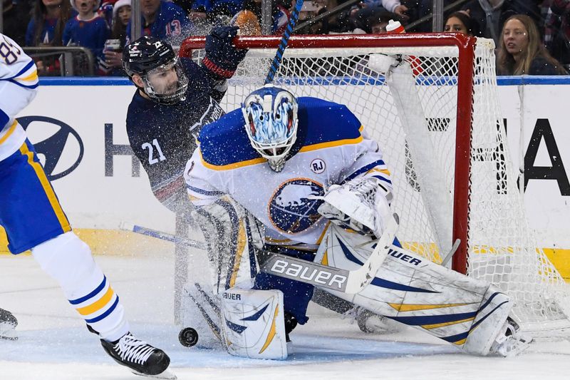 Dec 23, 2023; New York, New York, USA; New York Rangers center Barclay Goodrow (21) slides into Buffalo Sabres goaltender Ukko-Pekka Luukkonen (1) during the third period at Madison Square Garden. Mandatory Credit: Dennis Schneidler-USA TODAY Sports