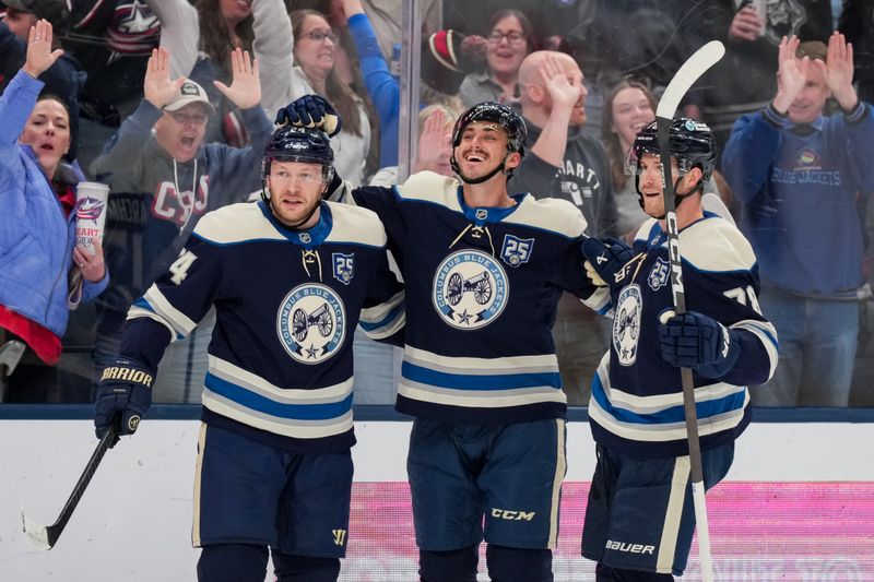 Feb 28, 2026; Columbus, Ohio, USA;  Columbus Blue Jackets left wing Mason Marchment, middle, celebrates with teammates after scoring a goal against the New York Islanders in the second period at Nationwide Arena. Mandatory Credit: Aaron Doster-Imagn Images