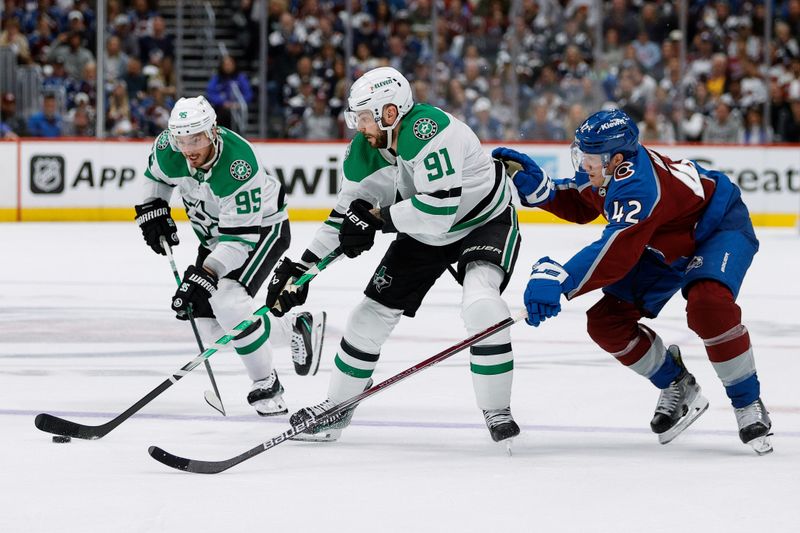 May 11, 2024; Denver, Colorado, USA; Dallas Stars center Tyler Seguin (91) controls the puck under pressure from Colorado Avalanche defenseman Josh Manson (42) as center Matt Duchene (95) defends in the first period in game three of the second round of the 2024 Stanley Cup Playoffs at Ball Arena. Mandatory Credit: Isaiah J. Downing-USA TODAY Sports