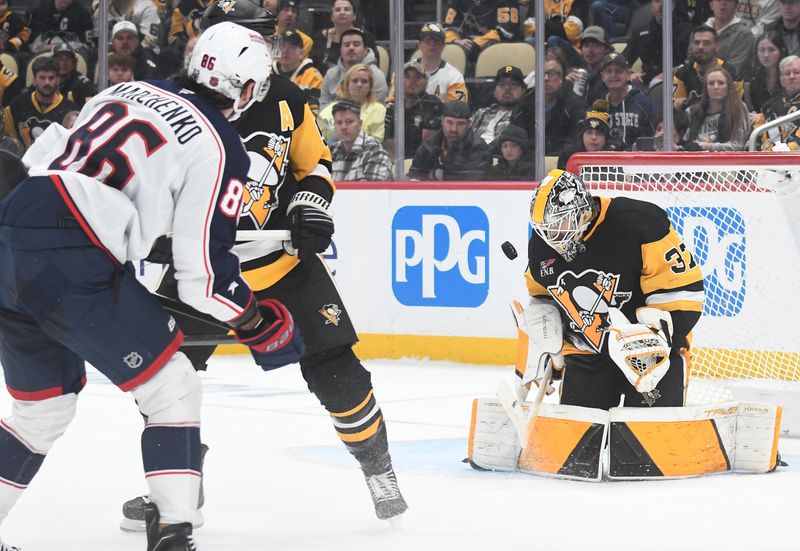 Oct 25, 2025; Pittsburgh, Pennsylvania, USA; Pittsburgh Penguins goalie Arturs Silovs (37) stops a shot in overtime by Columbus Blue Jackets right wing Kirill Marchenko (86) during overtime at PPG Paints Arena. The Blue Jackets won 5-4 in a shoot-out. Mandatory Credit: Philip G. Pavely-Imagn Images