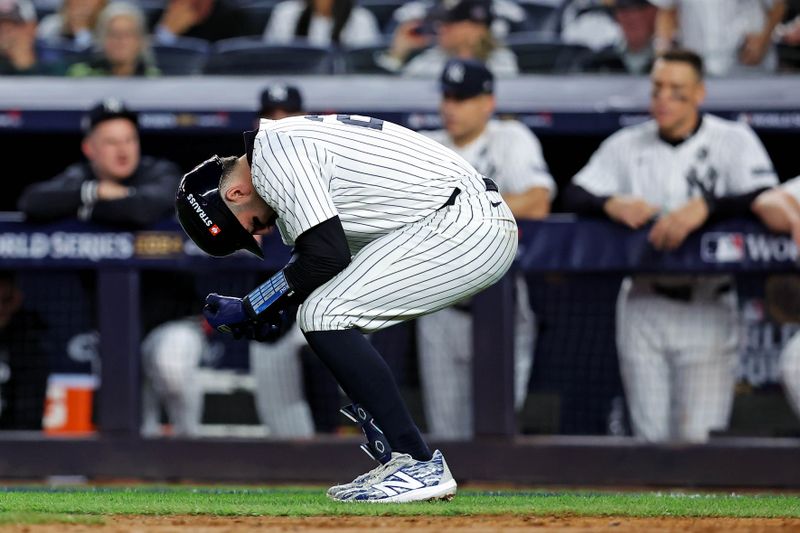 Oct 30, 2024; New York, New York, USA; New York Yankees catcher Austin Wells (28) is hit by a pitch during the fifth inning against the Los Angeles Dodgers in game four of the 2024 MLB World Series at Yankee Stadium. Mandatory Credit: Brad Penner-Imagn Images