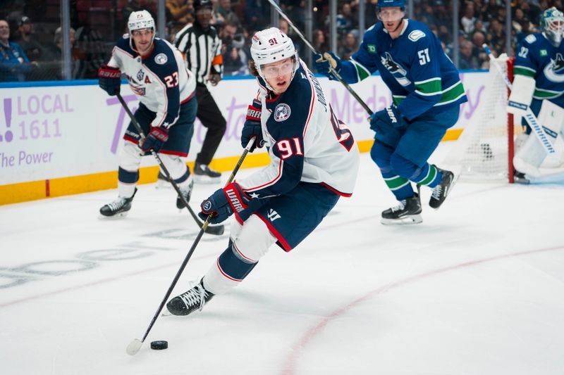 Nov 8, 2025; Vancouver, British Columbia, CAN; Columbus Blue Jackets forward Kent Johnson (91) handles the puck against the Vancouver Canucks in the first period at Rogers Arena. Mandatory Credit: Bob Frid-Imagn Images