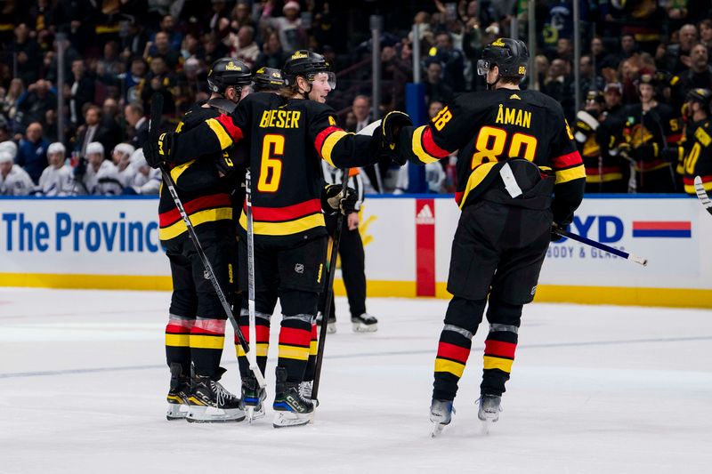 Dec 12, 2023; Vancouver, British Columbia, CAN; Vancouver Canucks defenseman Filip Hronek (17) and defenseman Quinn Hughes (43) and forward Brock Boeser (6) and forward Nils Aman (88) celebrate Boeser   s second goal of the game against the Tampa Bay Lightning in the second period at Rogers Arena. Mandatory Credit: Bob Frid-USA TODAY Sports