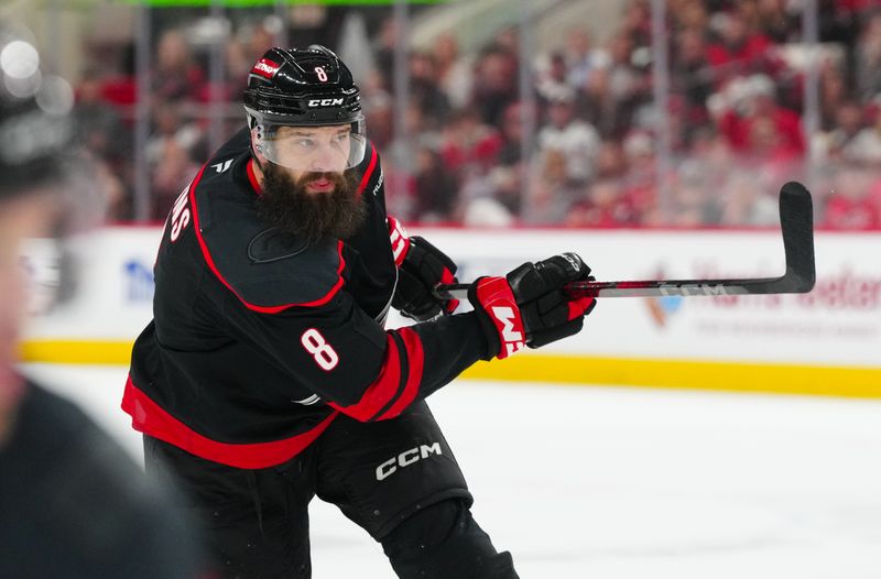 May 10, 2025; Raleigh, North Carolina, USA; Carolina Hurricanes defenseman Brent Burns (8) takes a shot against the Washington Capitals during the third period in game three of the second round of the 2025 Stanley Cup Playoffs at Lenovo Center. Mandatory Credit: James Guillory-Imagn Images