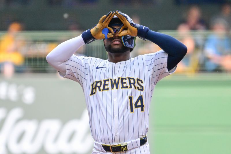 Jul 13, 2024; Milwaukee, Wisconsin, USA; Milwaukee Brewers second baseman Andruw Monasterio (14) reacts after hitting a double to drive in a run against the Washington Nationals in the first inning at American Family Field. Mandatory Credit: Benny Sieu-USA TODAY Sports