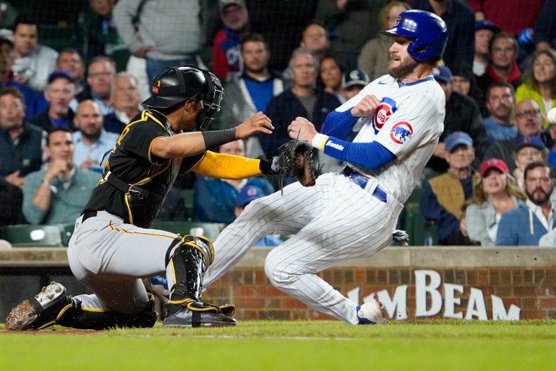 Sep 19, 2023; Chicago, Illinois, USA; Chicago Cubs first baseman Patrick Wisdom (16) is safe at home plate as Pittsburgh Pirates catcher Endy Rodriguez (25) makes a late tag during the second inning at Wrigley Field. Mandatory Credit: David Banks-USA TODAY Sports