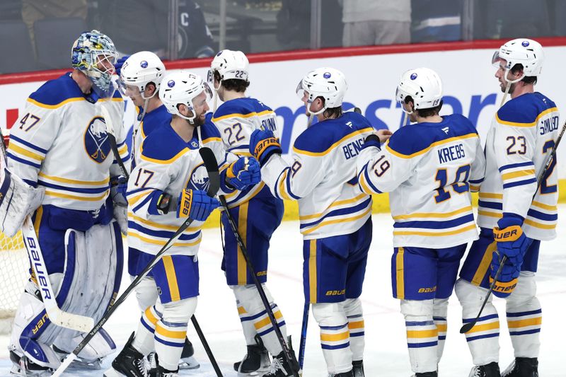 Mar 23, 2025; Winnipeg, Manitoba, CAN; Buffalo Sabres players celebrate after their victory against the Winnipeg Jets at Canada Life Centre. Mandatory Credit: James Carey Lauder-Imagn Images