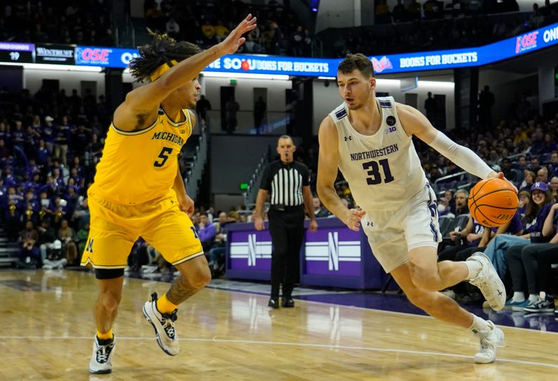 Feb 2, 2023; Evanston, Illinois, USA; Michigan Wolverines forward Terrance Williams II (5) defends Northwestern Wildcats forward Robbie Beran (31) during the second half at Welsh-Ryan Arena. Mandatory Credit: David Banks-USA TODAY Sports