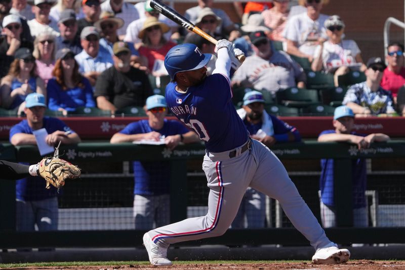 Mar 1, 2024; Scottsdale, Arizona, USA; Texas Rangers shortstop Ezequiel Duran bats against the San Francisco Giants during the second inning at Scottsdale Stadium. Mandatory Credit: Joe Camporeale-USA TODAY Sports