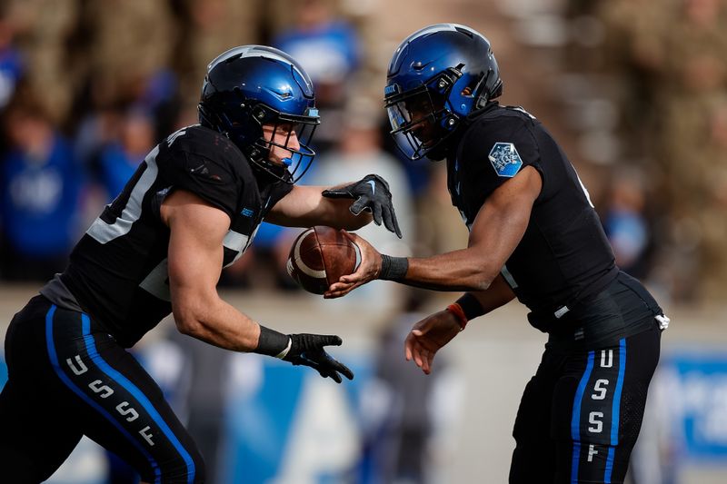 Nov 12, 2022; Colorado Springs, Colorado, USA; Air Force Falcons quarterback Haaziq Daniels (4) hands the ball off to running back Brad Roberts (20) in the second quarter against the New Mexico Lobos at Falcon Stadium. Mandatory Credit: Isaiah J. Downing-USA TODAY Sports