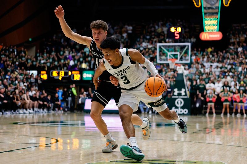 Feb 17, 2024; Fort Collins, Colorado, USA; Colorado State Rams guard Josiah Strong (3) controls the ball as Utah State Aggies guard Mason Falslev (12) guards in the second half at Moby Arena. Mandatory Credit: Isaiah J. Downing-USA TODAY Sports