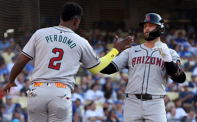 Jul 4, 2024; Los Angeles, California, USA; Arizona Diamondbacks first baseman Christian Walker (53) celebrates with shortstop Geraldo Perdomo (2) after a home run during the first inning against the Los Angeles Dodgers at Dodger Stadium. Mandatory Credit: Jason Parkhurst-USA TODAY Sports