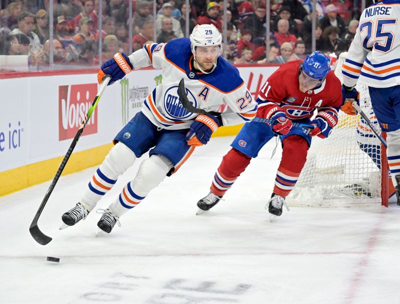 Jan 13, 2024; Montreal, Quebec, CAN; Edmonton Oilers forward Leon Draisaitl (29) plays the puck and Montreal Canadiens forward Brendan Gallagher (11) defends during the second period at the Bell Centre. Mandatory Credit: Eric Bolte-USA TODAY Sports