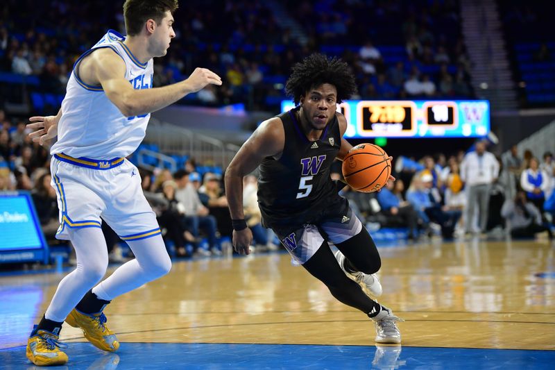 January 14, 2024; Los Angeles, California, USA; Washington Huskies guard Sahvir Wheeler (5) moves to the basket against UCLA Bruins guard Lazar Stefanovic (10) during the first half at Pauley Pavilion. Mandatory Credit: Gary A. Vasquez-USA TODAY Sports