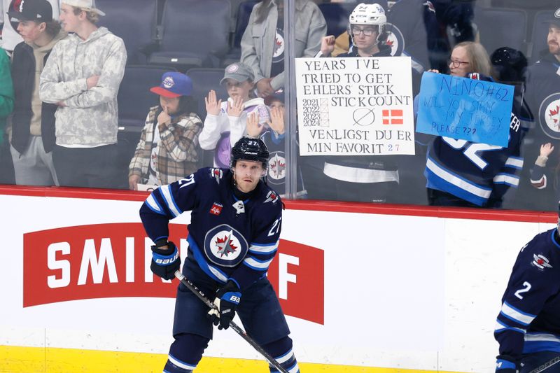 Jan 2, 2024; Winnipeg, Manitoba, CAN; Winnipeg Jets left wing Nikolaj Ehlers (27) skates past fans before a game against the Tampa Bay Lightning at Canada Life Centre. Mandatory Credit: James Carey Lauder-USA TODAY Sports